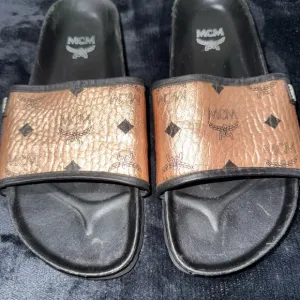 MCM Tan and Black Logo Slides